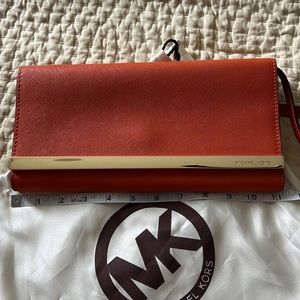 Orange clutch bag with removable strap